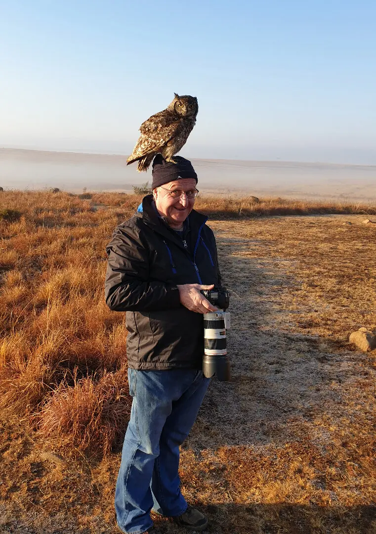 Derek with a wood owl on his head.